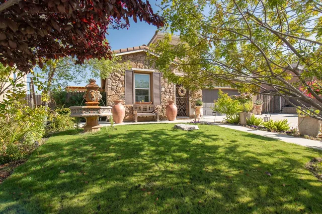a view of a house with a backyard