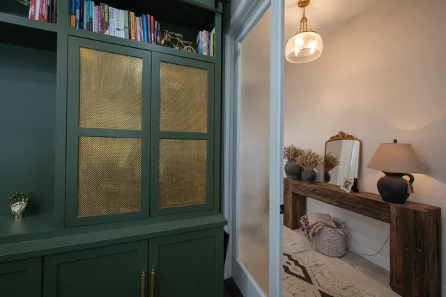a view of a workspace with furniture and a window