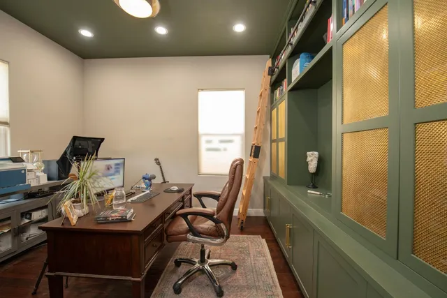a view of a hallway with workspace and a livingroom