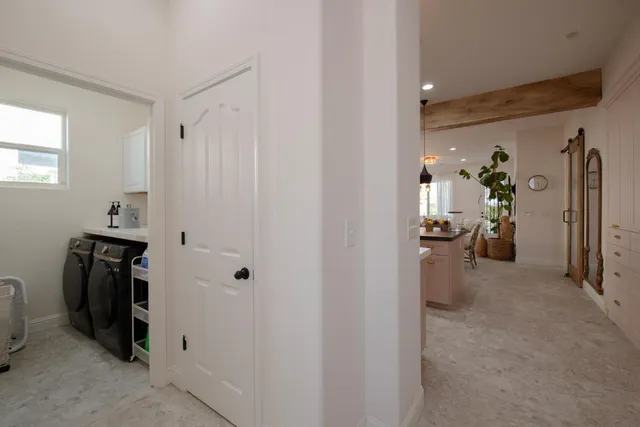 a kitchen with kitchen island granite countertop a sink and refrigerator