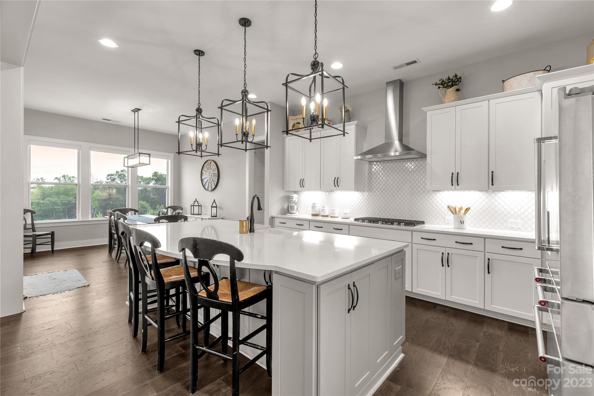 844 Bee Balm Trail Fort Mill, SC 29708 - Photo 11 of 48 a kitchen with stainless steel appliances granite countertop a stove a refrigerator a kitchen island a table and chairs