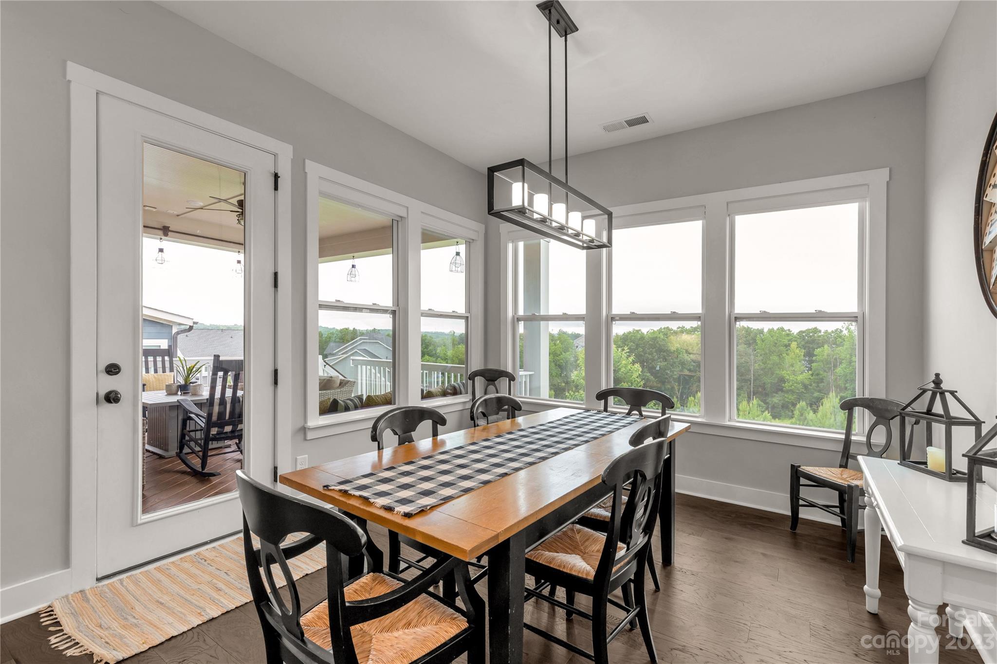 844 Bee Balm Trail Fort Mill, SC 29708 - Photo 12 of 48 a dining room with furniture a chandelier and wooden floor