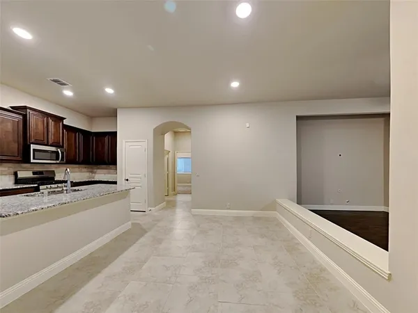 a view of a kitchen with a sink and a refrigerator