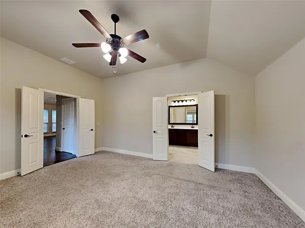 an empty room with closet and windows