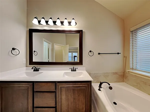 a bathroom with a sink vanity and a mirror