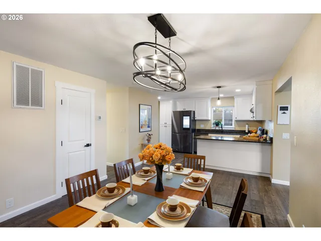 a living room with kitchen island furniture and a chandelier
