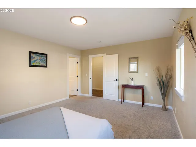 a bedroom with a bed and a potted plant