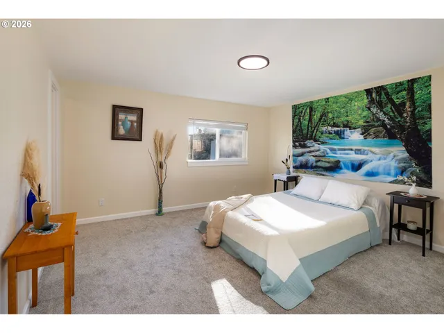 a bedroom with a bed and a large window