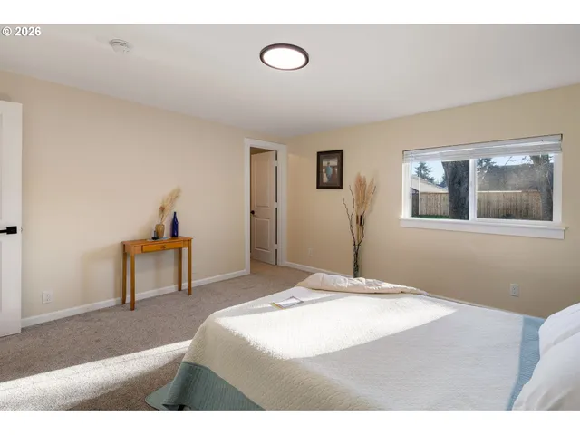 a bedroom with a bed and a painting on the wall