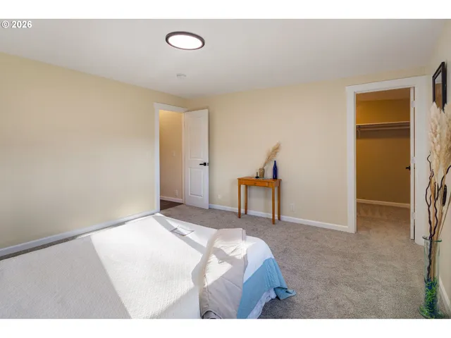 a bedroom with a bed and a chair