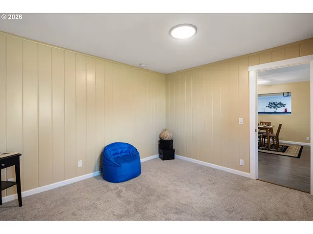 a bedroom with a bed and a painting on the wall