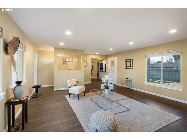a living room with furniture and large window