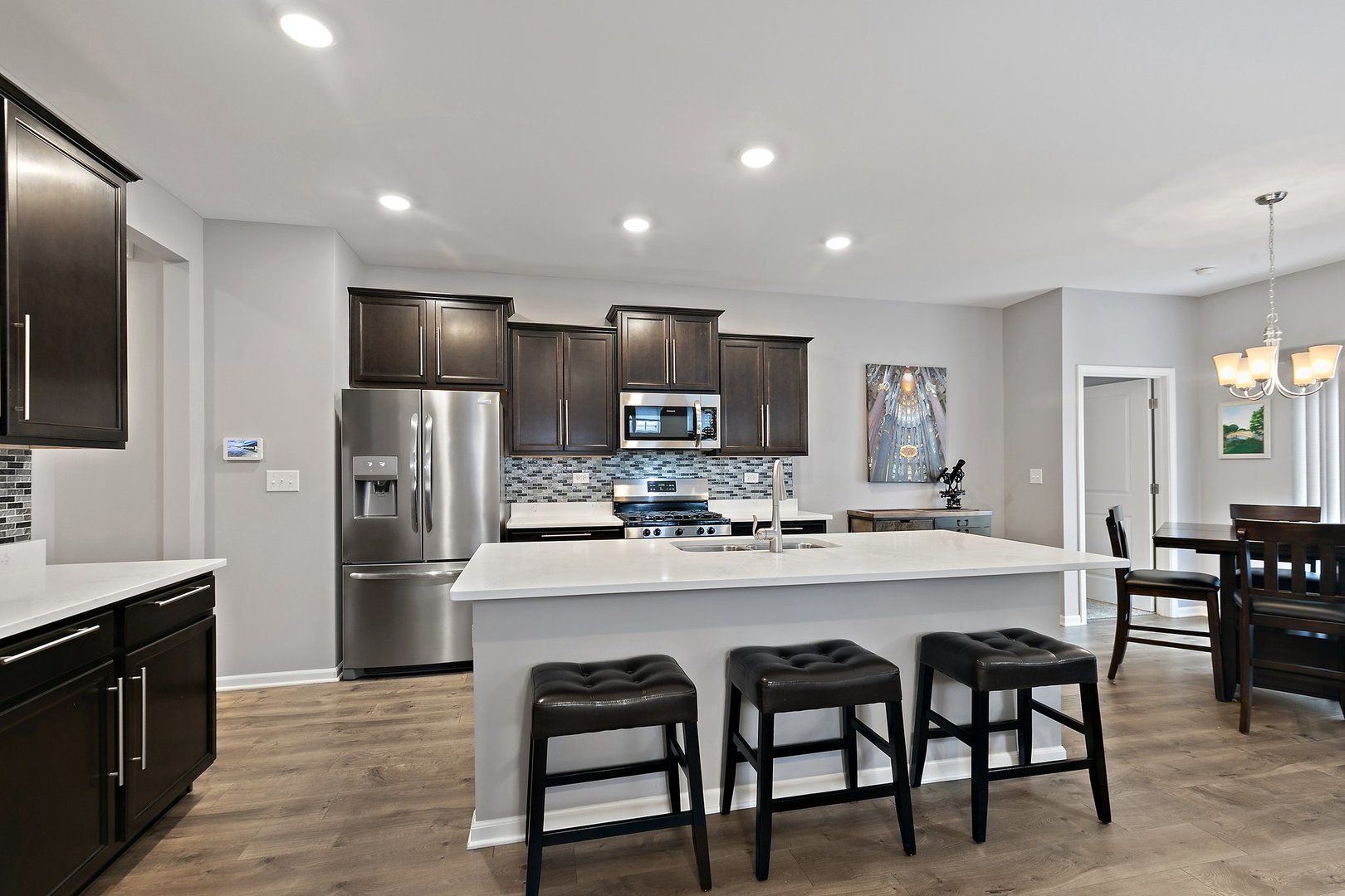 1979 Southern Circle, Unit 1979 Pingree Grove, IL 60140 - Photo 5 of 22 a kitchen with refrigerator and chairs