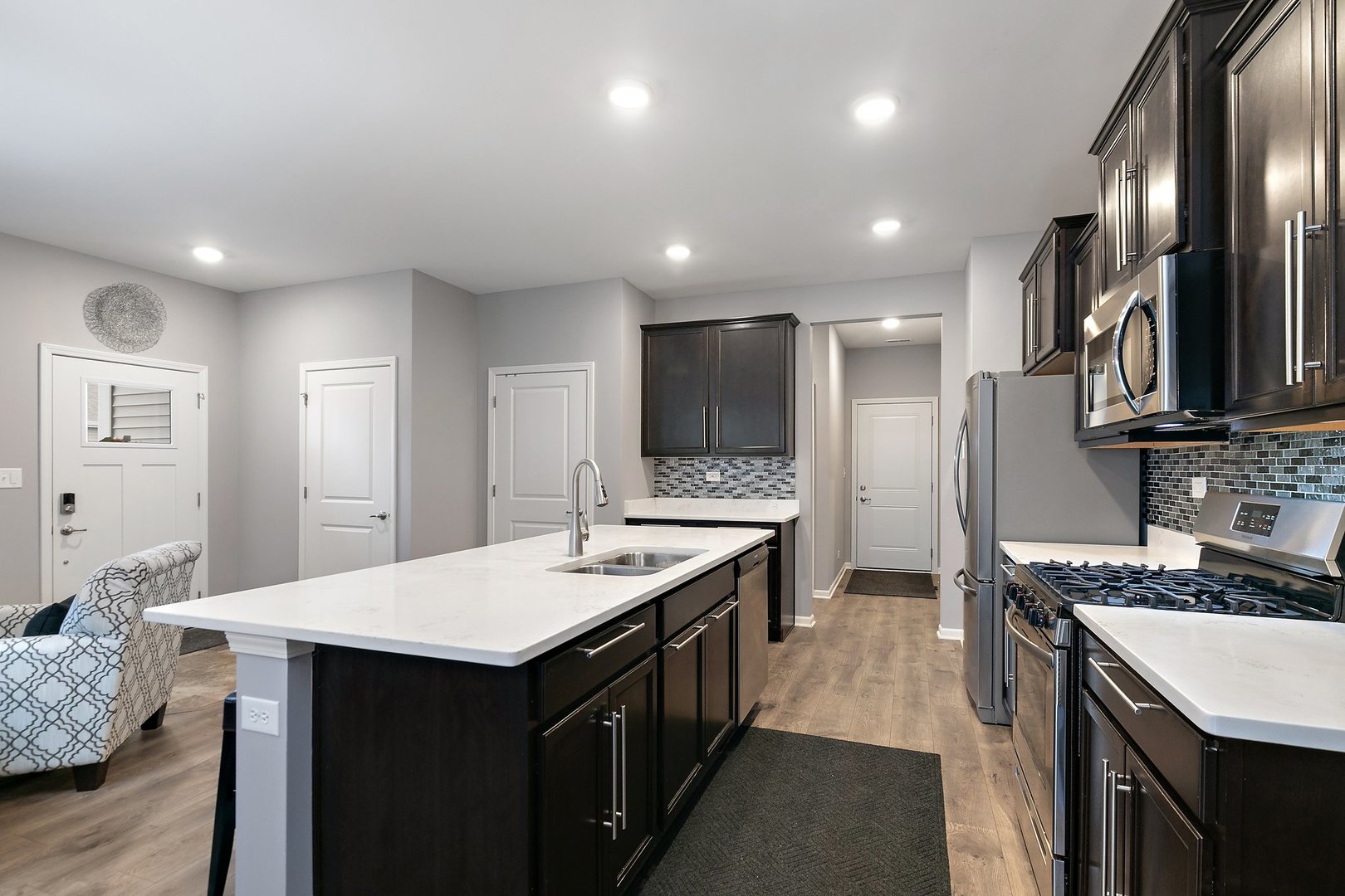 1979 Southern Circle, Unit 1979 Pingree Grove, IL 60140 - Photo 7 of 22 a kitchen with granite countertop a sink stove and refrigerator