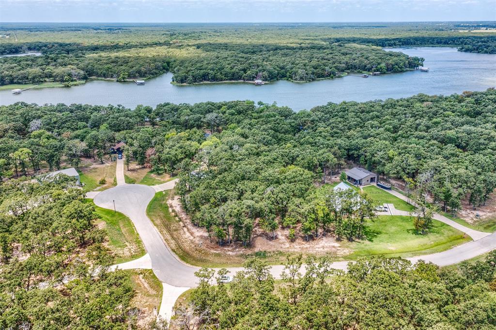 Drone / aerial view of a large body of water and a heavily wooded area