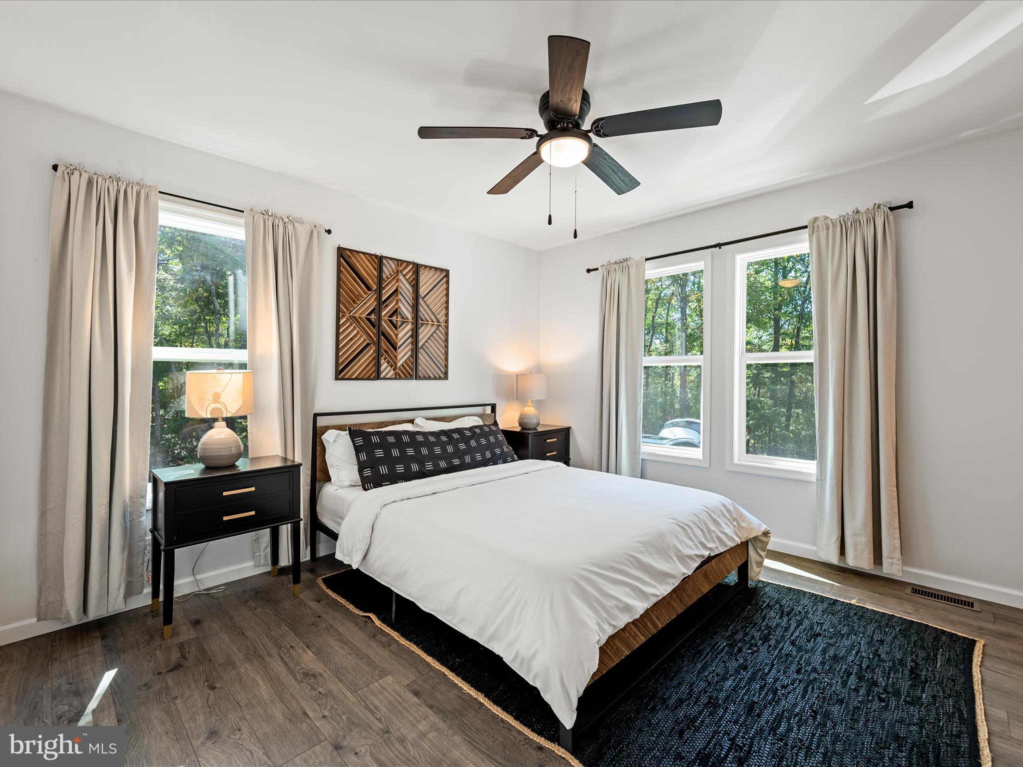 8650 Supinlick Ridge Road Mount Jackson, VA 22842 - Photo 27 of 62 a bedroom with a large bed and a large window