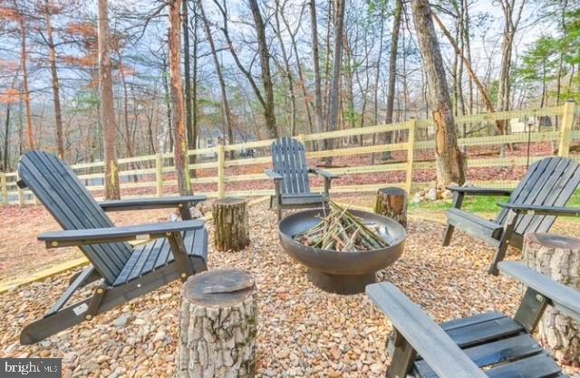 8650 Supinlick Ridge Road Mount Jackson, VA 22842 - Photo 33 of 62 a view of a patio with couches chairs and wooden floor