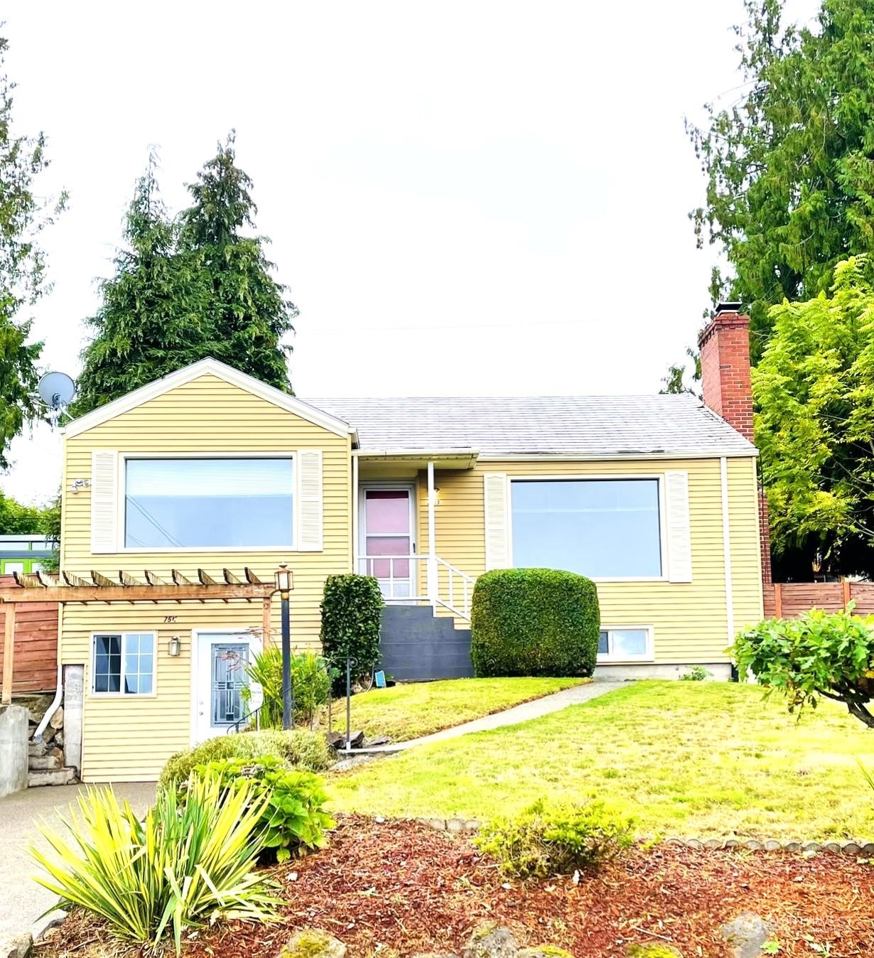 7513 South Sunnycrest Road Seattle, WA 98178 - Photo 1 of 16 a front view of a house with a yard and garage