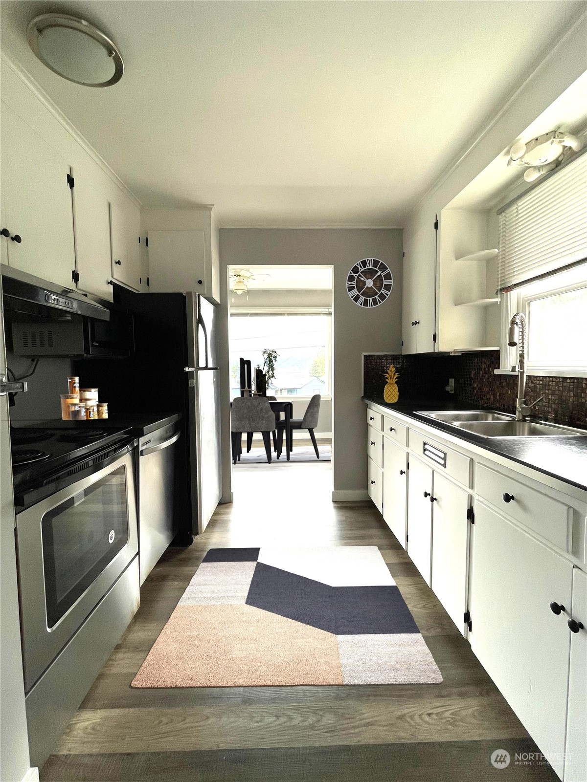 7513 South Sunnycrest Road Seattle, WA 98178 - Photo 5 of 16 a kitchen with granite countertop a refrigerator and a stove top oven