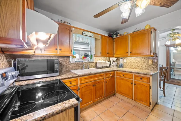 a kitchen with stainless steel appliances a stove sink and microwave