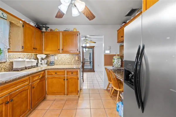 a kitchen with stainless steel appliances granite countertop a sink and cabinets