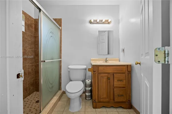 a bathroom with a toilet a sink and shower
