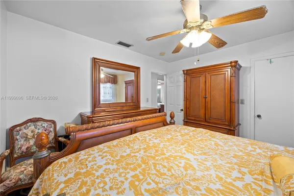 a bedroom with two beds and a chandelier