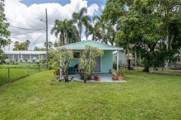 a view of a tree in front of a house