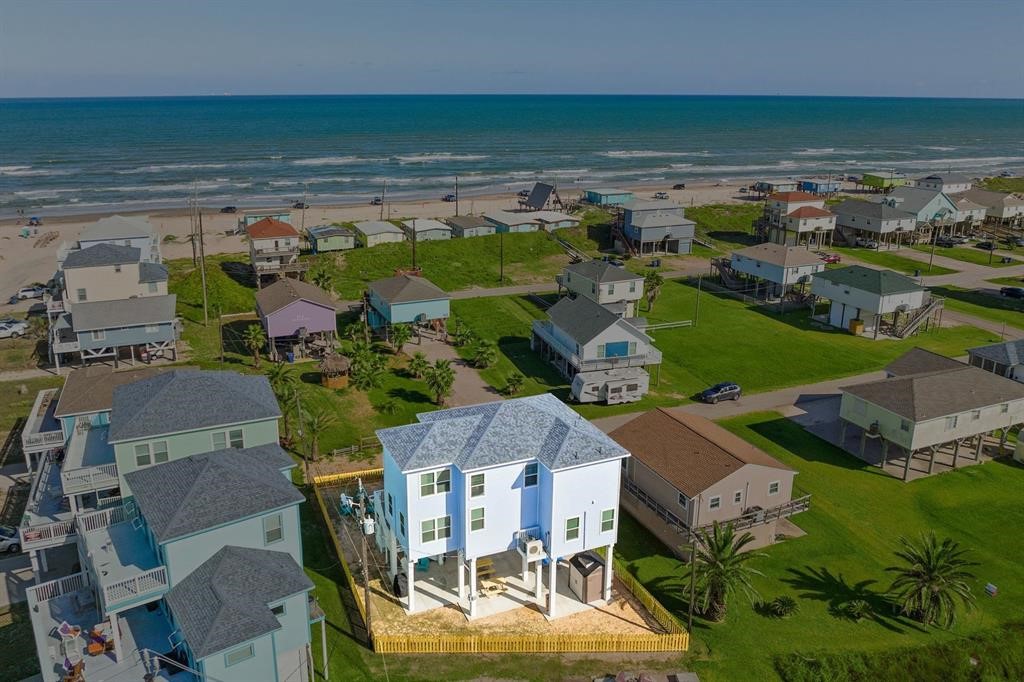 Elevated coastal home just steps from the beach, offering beautiful ocean views and a fenced yard for outdoor enjoyment.