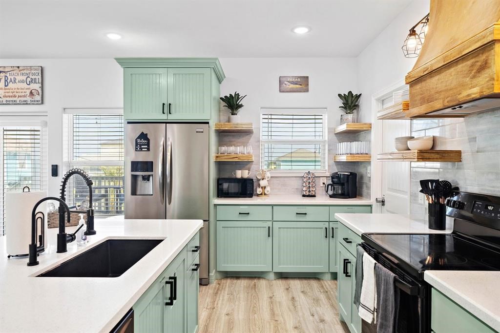 622 Crane Court Surfside Beach, TX 77541 - Photo 2 of 30 a kitchen with a sink cabinets and window