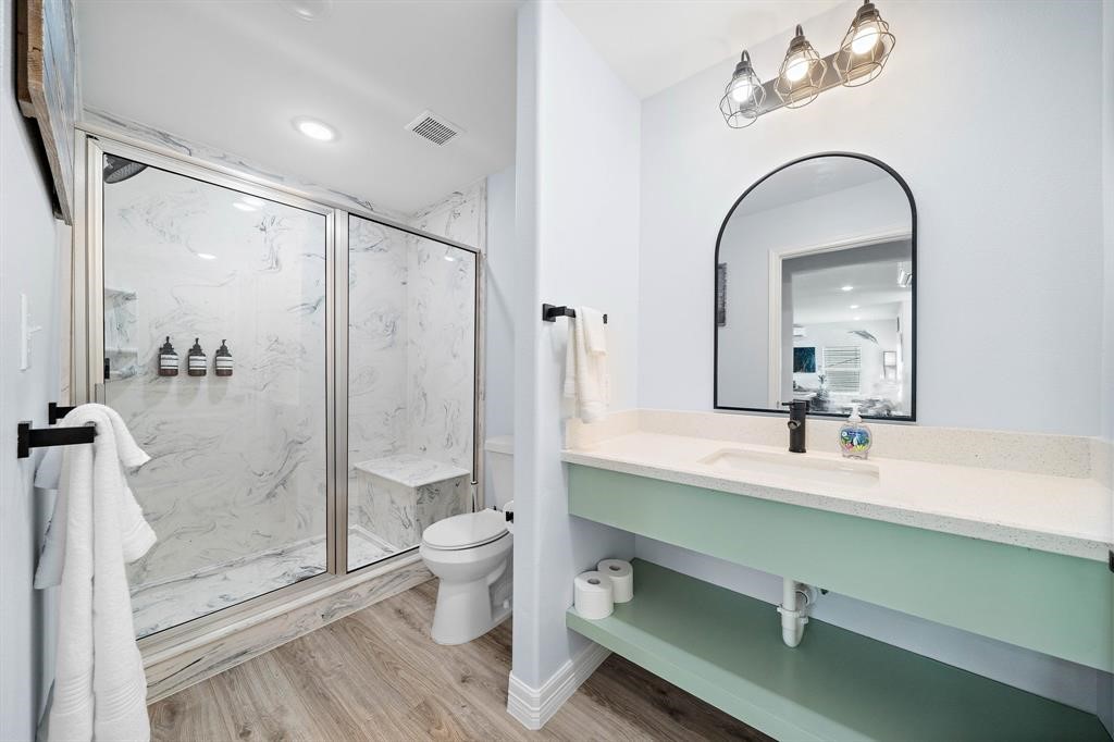 622 Crane Court Surfside Beach, TX 77541 - Photo 22 of 30 a bathroom with a double vanity sink toilet and shower