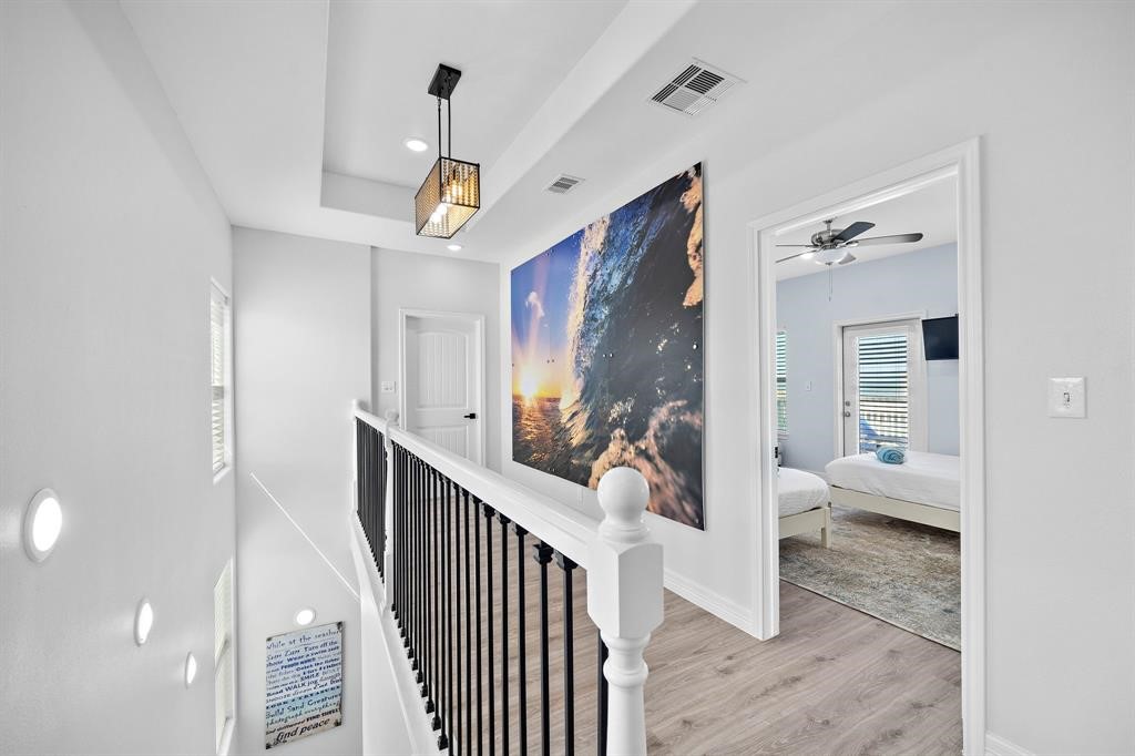 622 Crane Court Surfside Beach, TX 77541 - Photo 23 of 30 a view of a hallway view with living room and wooden floor