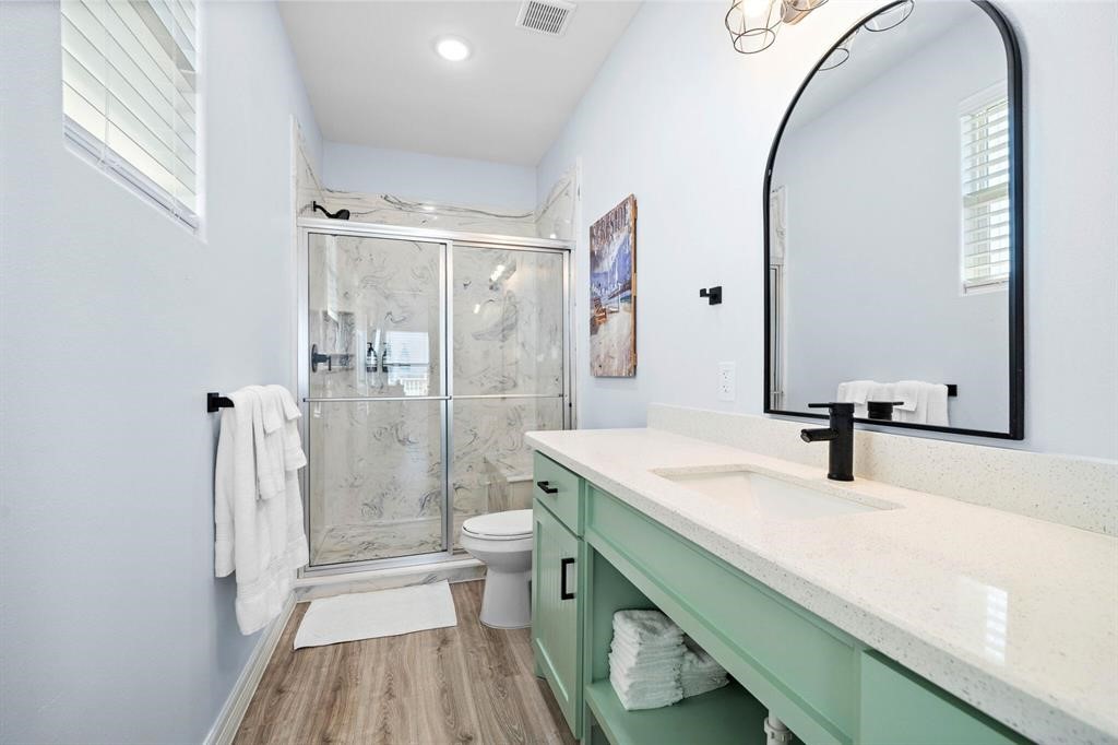 622 Crane Court Surfside Beach, TX 77541 - Photo 26 of 30 a bathroom with a sink a toilet and a mirror