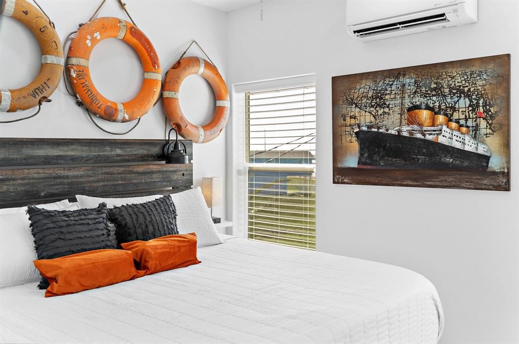 622 Crane Court Surfside Beach, TX 77541 - Photo 6 of 30 a bedroom with bed and a painting on the wall
