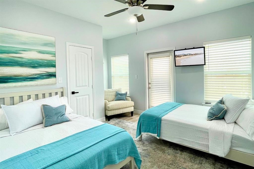622 Crane Court Surfside Beach, TX 77541 - Photo 8 of 30 a bedroom with a bed and a chandelier