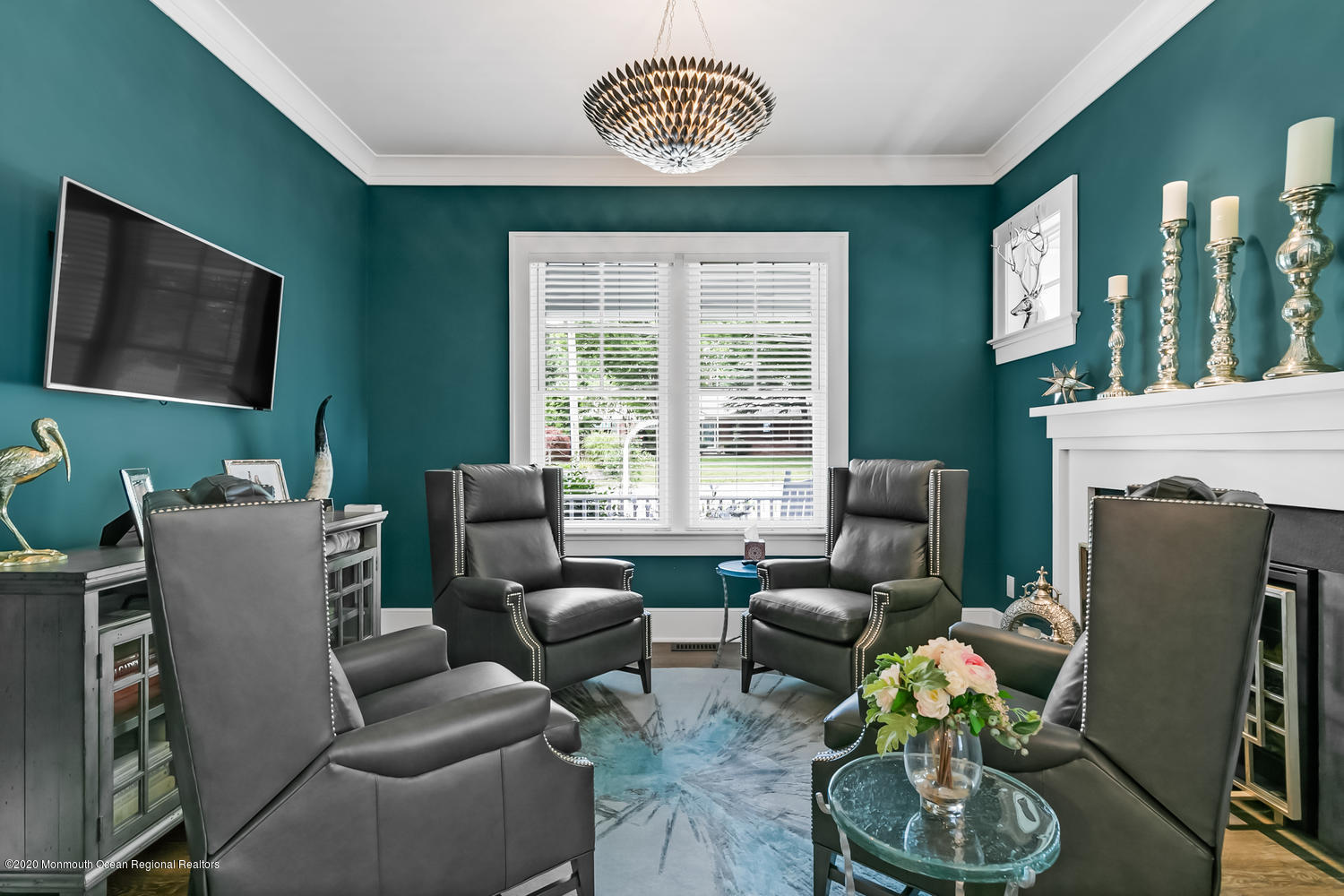 1008 Forrest Road Brielle, NJ 08730 - Photo 24 of 81 a living room with furniture a fireplace and a flat screen tv