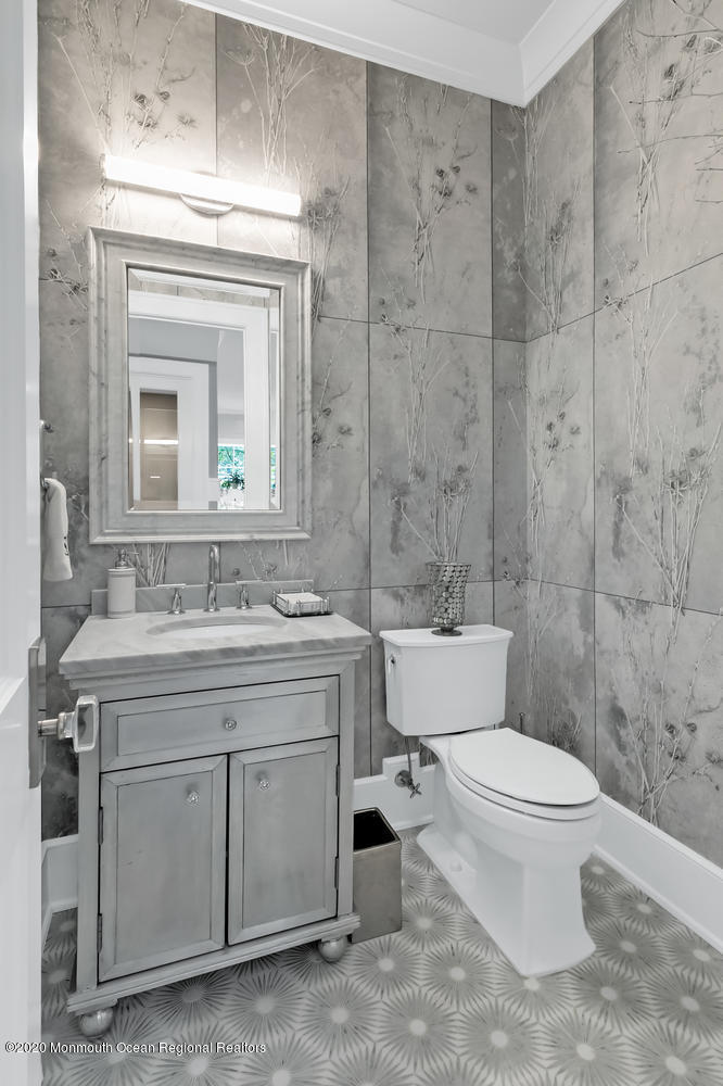 1008 Forrest Road Brielle, NJ 08730 - Photo 28 of 81 a bathroom with a toilet a sink and mirror