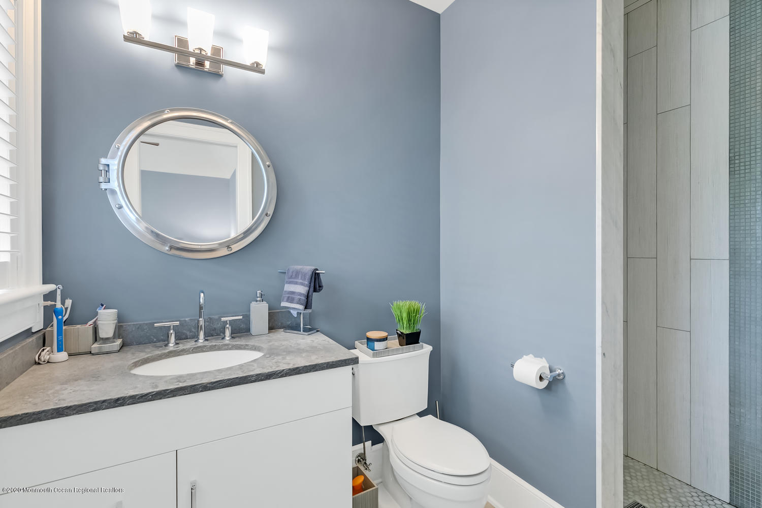 1008 Forrest Road Brielle, NJ 08730 - Photo 32 of 81 a bathroom with a granite countertop toilet a sink and mirror