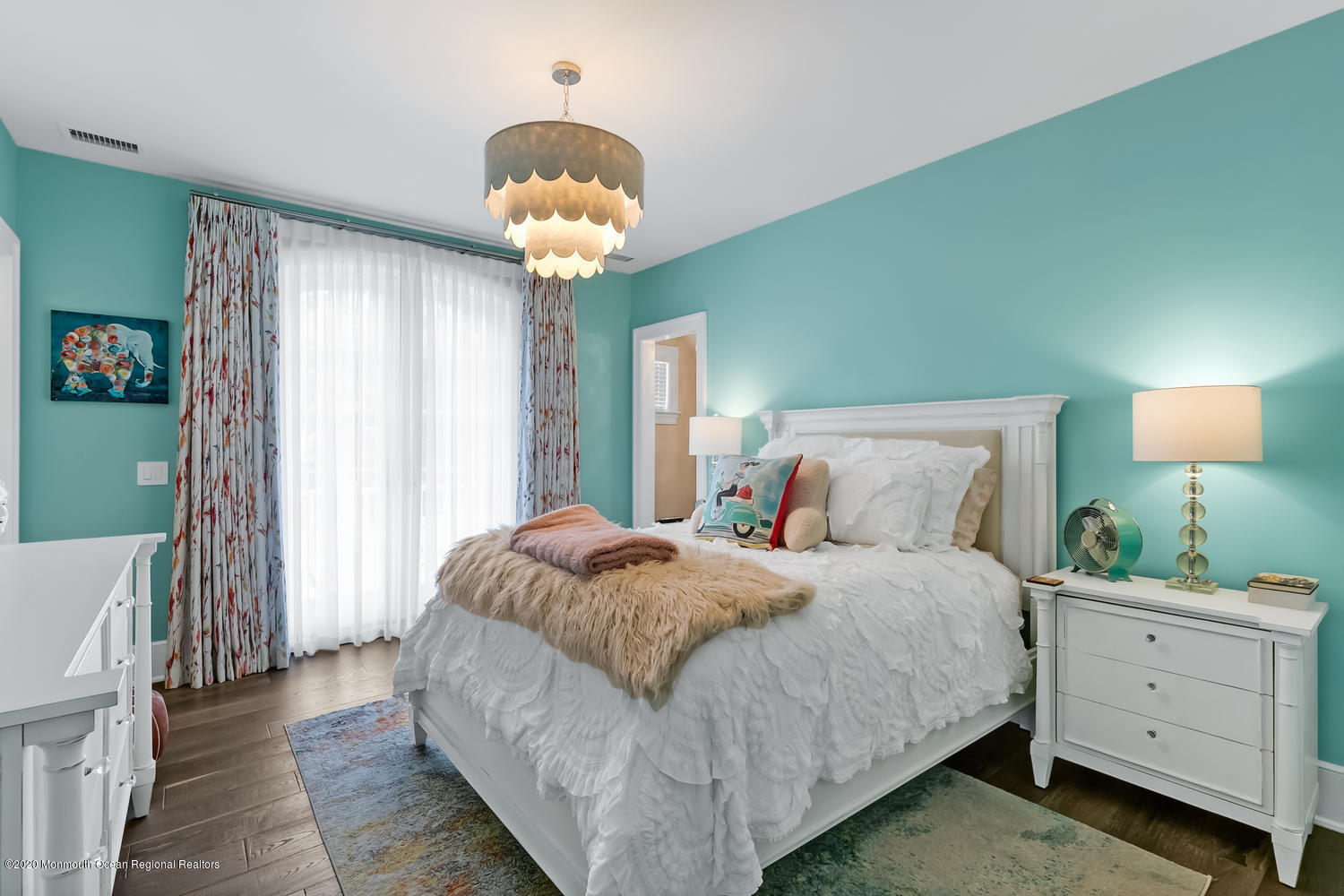 1008 Forrest Road Brielle, NJ 08730 - Photo 34 of 81 a spacious bedroom with a bed and a chandelier