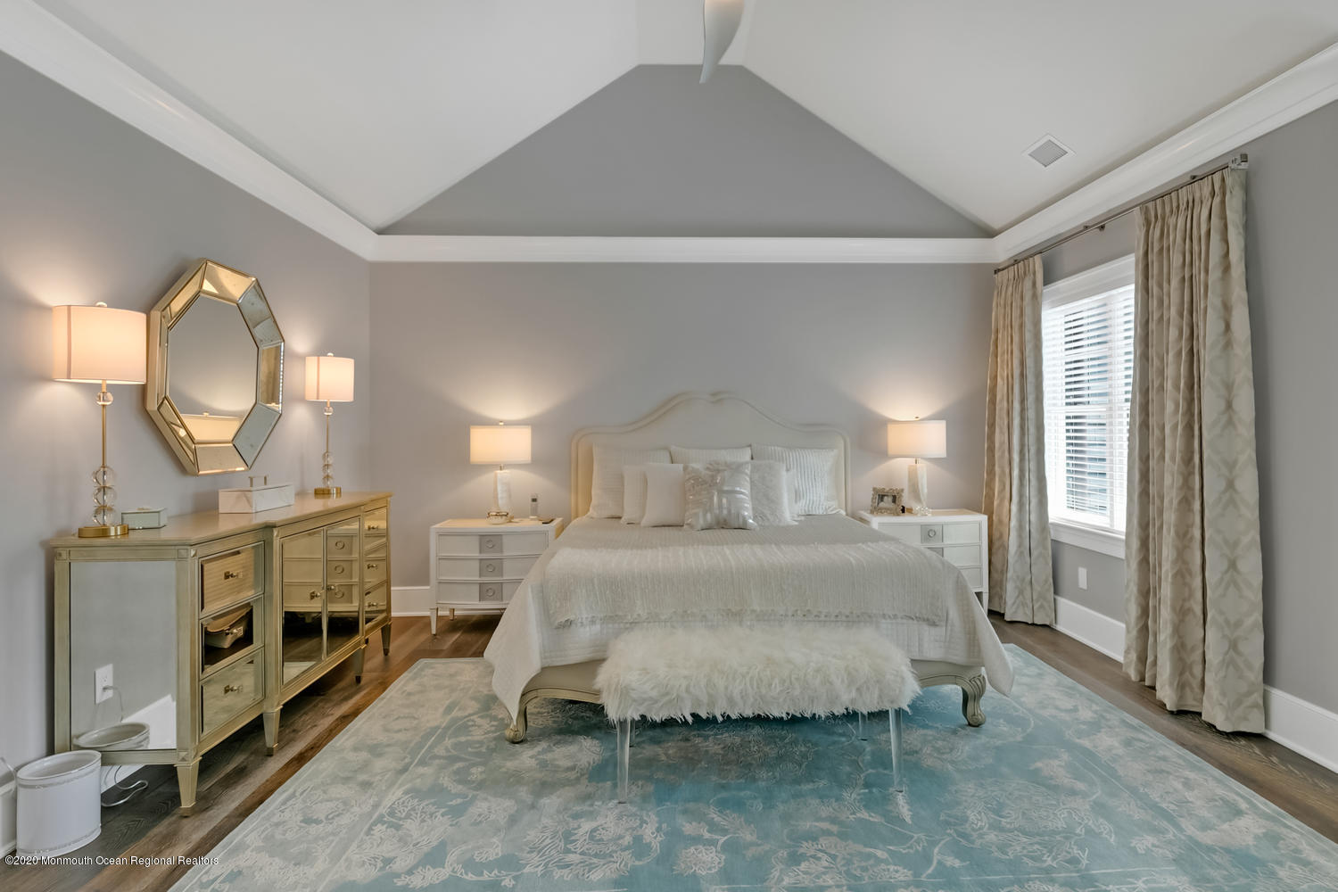 1008 Forrest Road Brielle, NJ 08730 - Photo 39 of 81 a bedroom with a bed a mirror on dresser and a chandelier