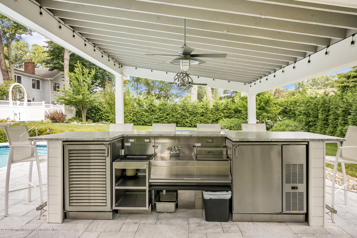 1008 Forrest Road Brielle, NJ 08730 - Photo 59 of 81 a view of a patio with table and chairs under an umbrella