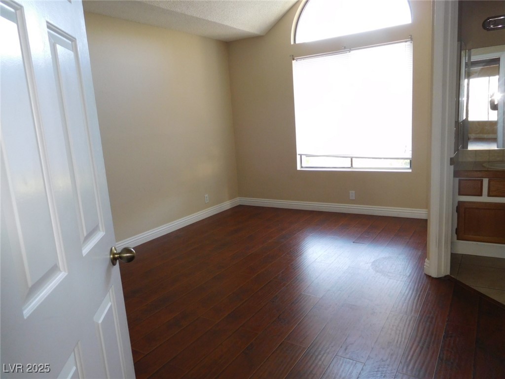 3220 Tocata Drive Las Vegas, NV 89146 - Photo 11 of 12 Spare room featuring lofted ceiling, baseboards, a