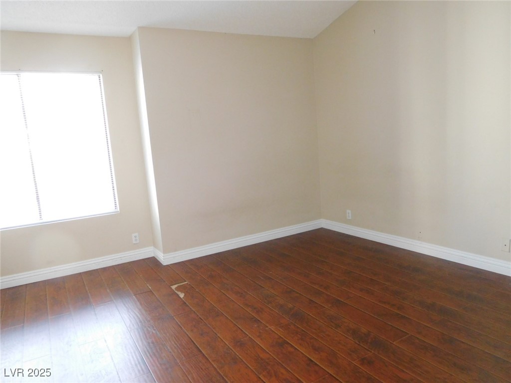 3220 Tocata Drive Las Vegas, NV 89146 - Photo 7 of 12 Spare room with dark wood-type flooring and basebo