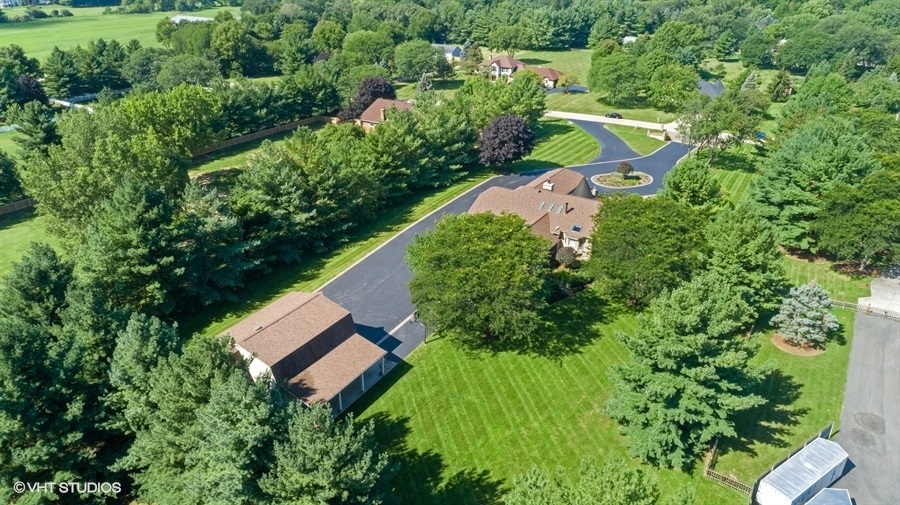 5N695 Dunham Trails Road Wayne, IL 60184 - Photo 40 of 48 an aerial view of a house with a yard and trees all around