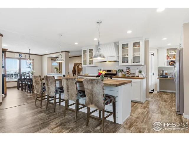 a kitchen with stainless steel appliances granite countertop a stove top oven a refrigerator a sink and a island