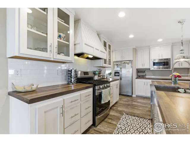 a kitchen with white cabinets and sink