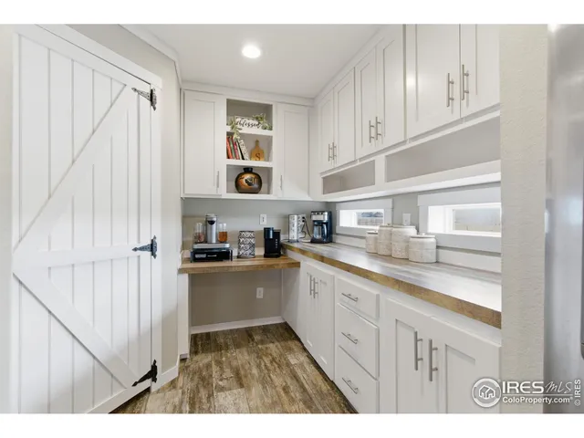 a utility room with lots of clutter and refrigerator