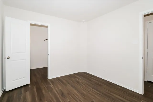 a view of a small space with wooden floor and a window