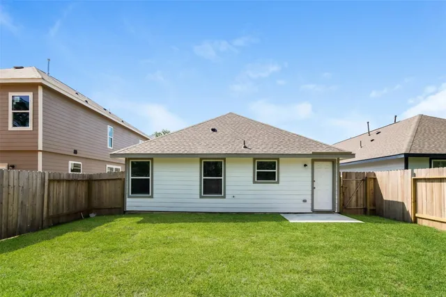 a backyard of a house with barbeque oven