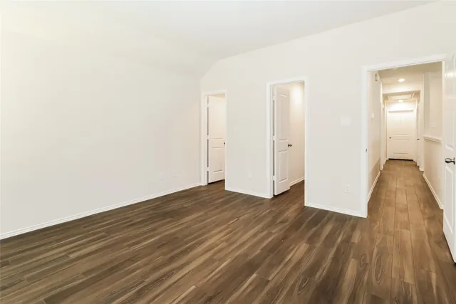 a view of a room with wooden floor and a sink